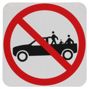 It is not legal for people or pets to ride in the back of a pickup truck in many states.